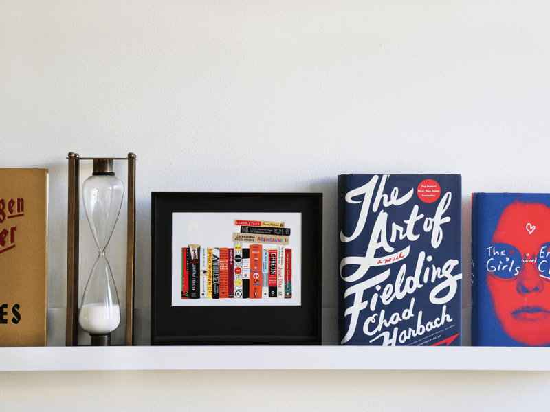 simply framed new school metal frame in matte black on a shelf featuring artwork by Ideal Bookshelf