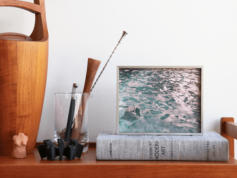 simply framed new school metal frame in warm silver in an interior featuring artwork by hamish robertson