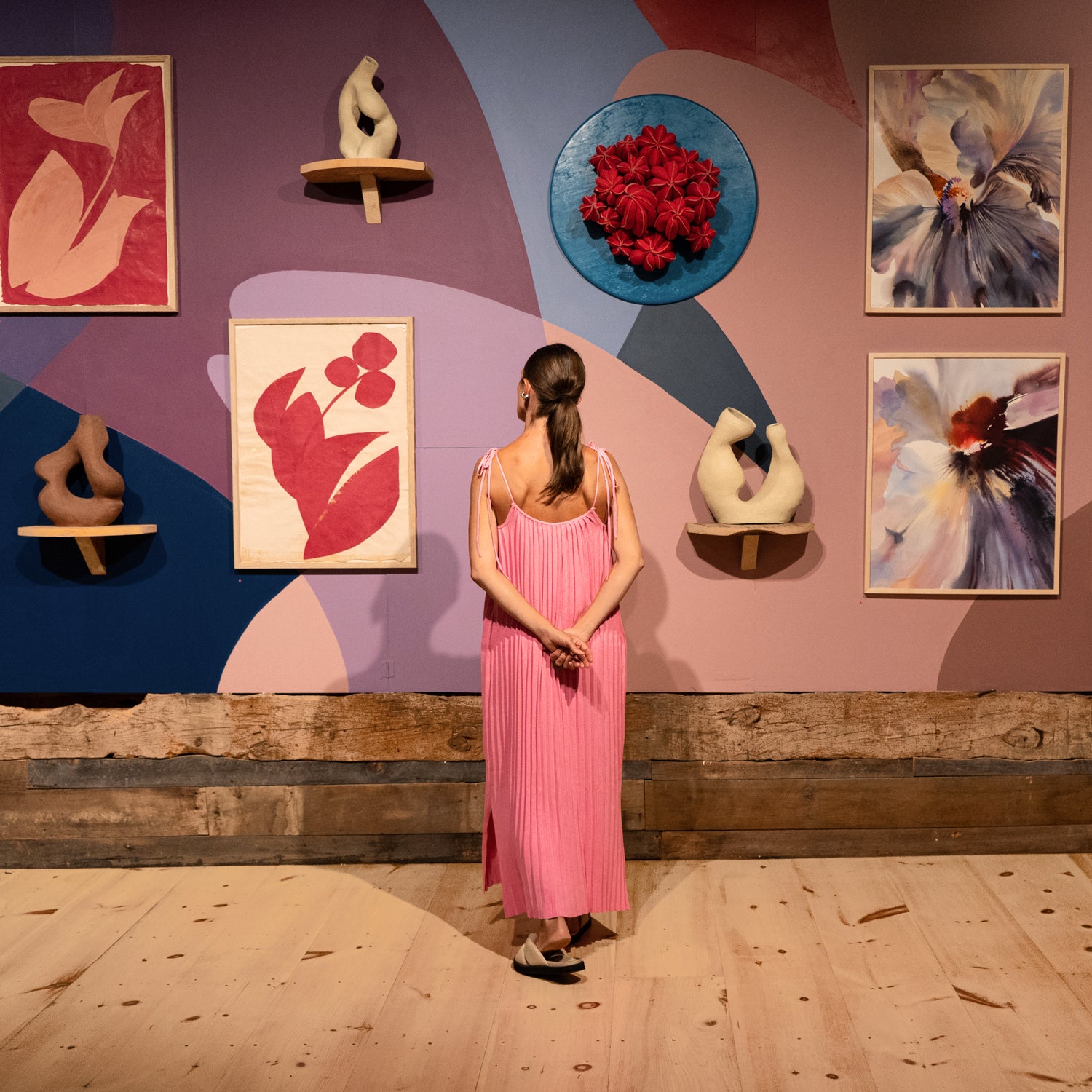 Woman appreciating beautiful colorful artwork in showcase displayed on a bright mural