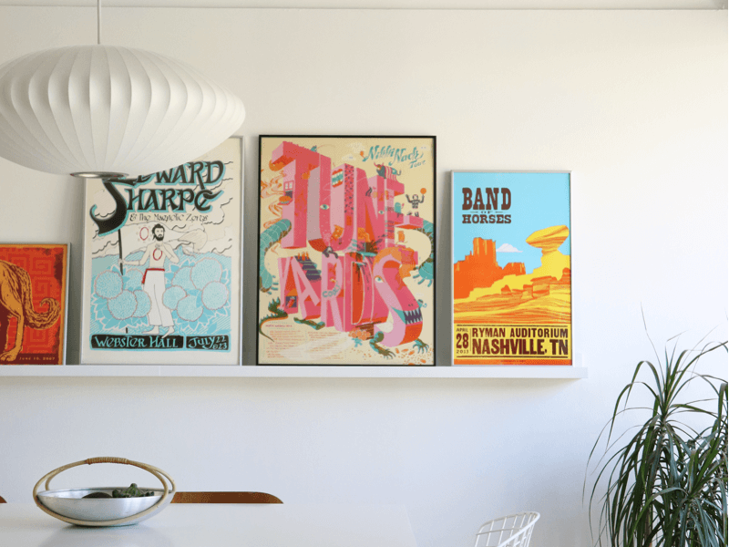 simply framed metal old school frames featuring concert posters in a dining room